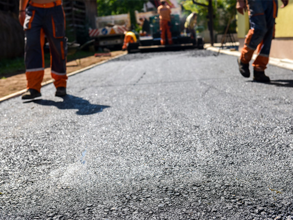 crew in uniform paving a new driveway