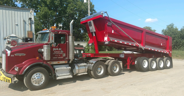 Large, red, R&R Paving branded dump truck